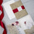 Glitter Gold burgundy laser cut Pocket Fold invitation with Red Satin belly band and Floral backer
